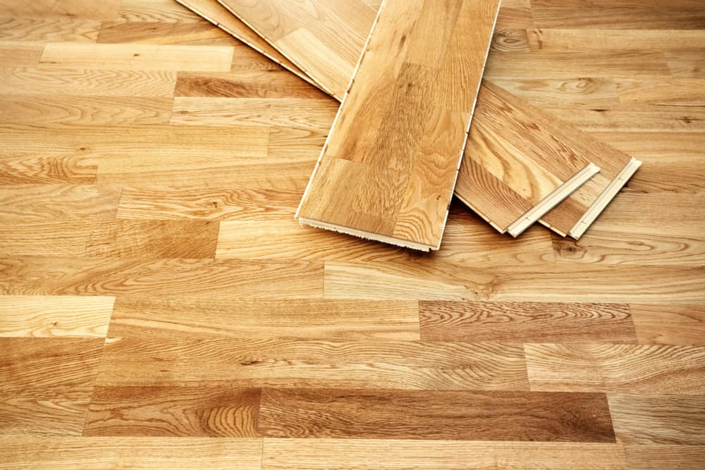 Restoring Engineered Wood Flooring | Engineered Wooden flooring with a couple pieces laid on top