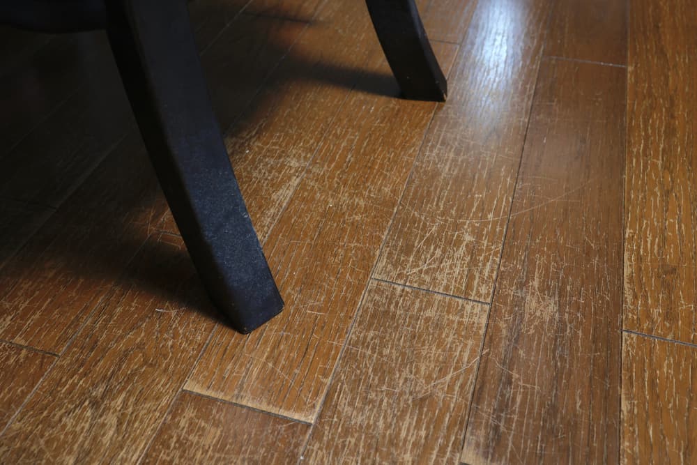 Wooden floor repair | Chair legs on a scuffed wooden floor