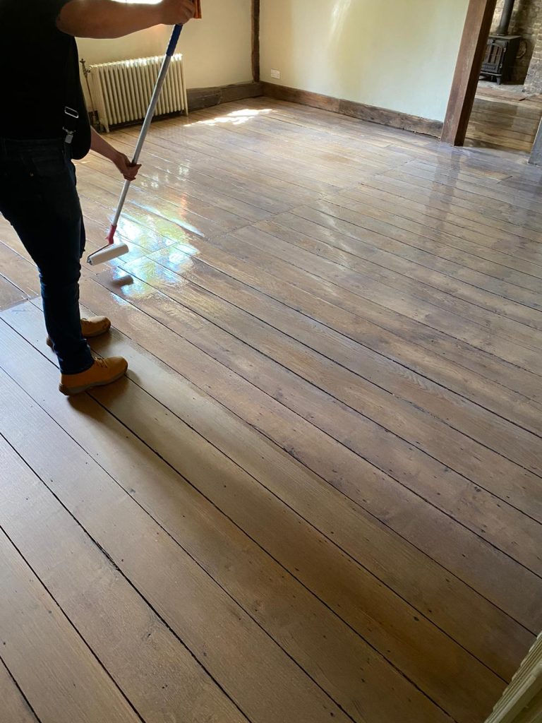 Hotel Wood Flooring Restoration | putting oil on a wood floor