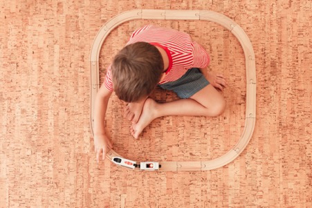 Is cork flooring sustainable | child sitting on cork flooring
