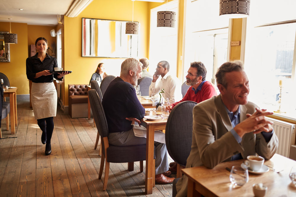 Best wood flooring for restaurants | people eating in a restaurant