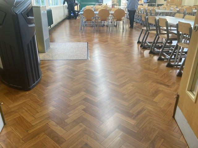 Hardfloor Restoration | restored floor in a school dining hall