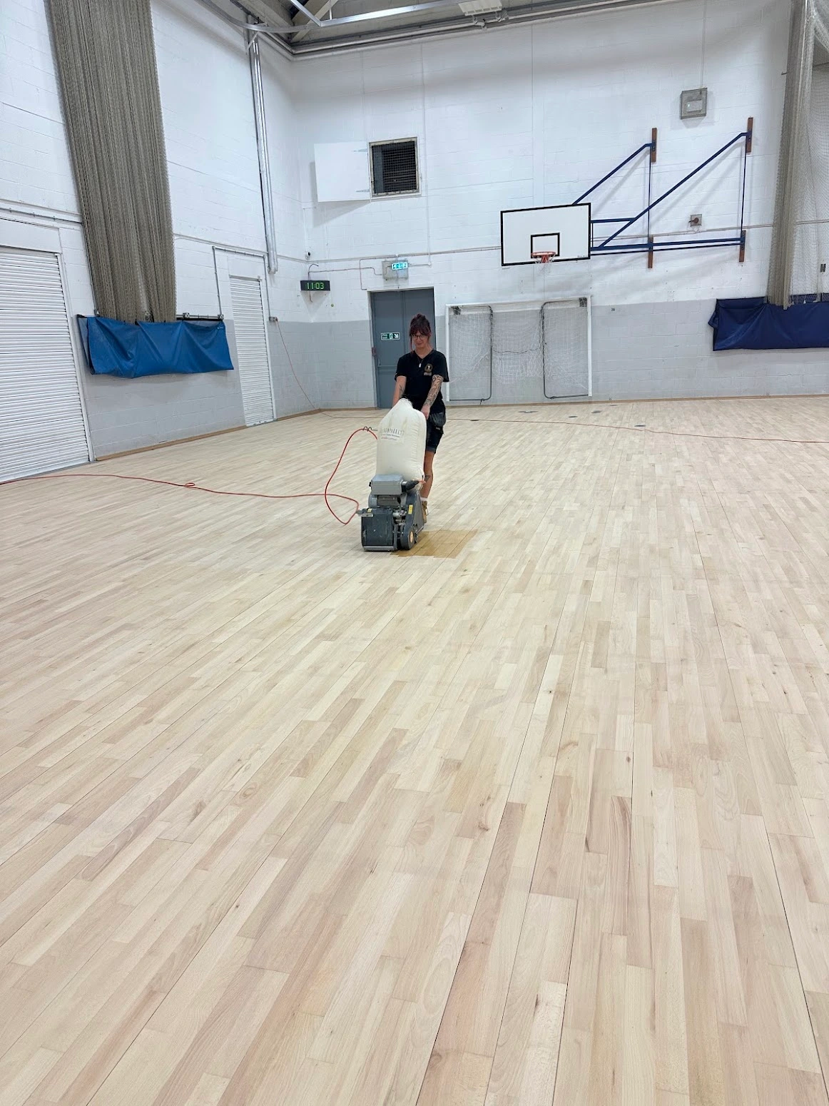 local floor sanding experts at work in a school gym in sussex