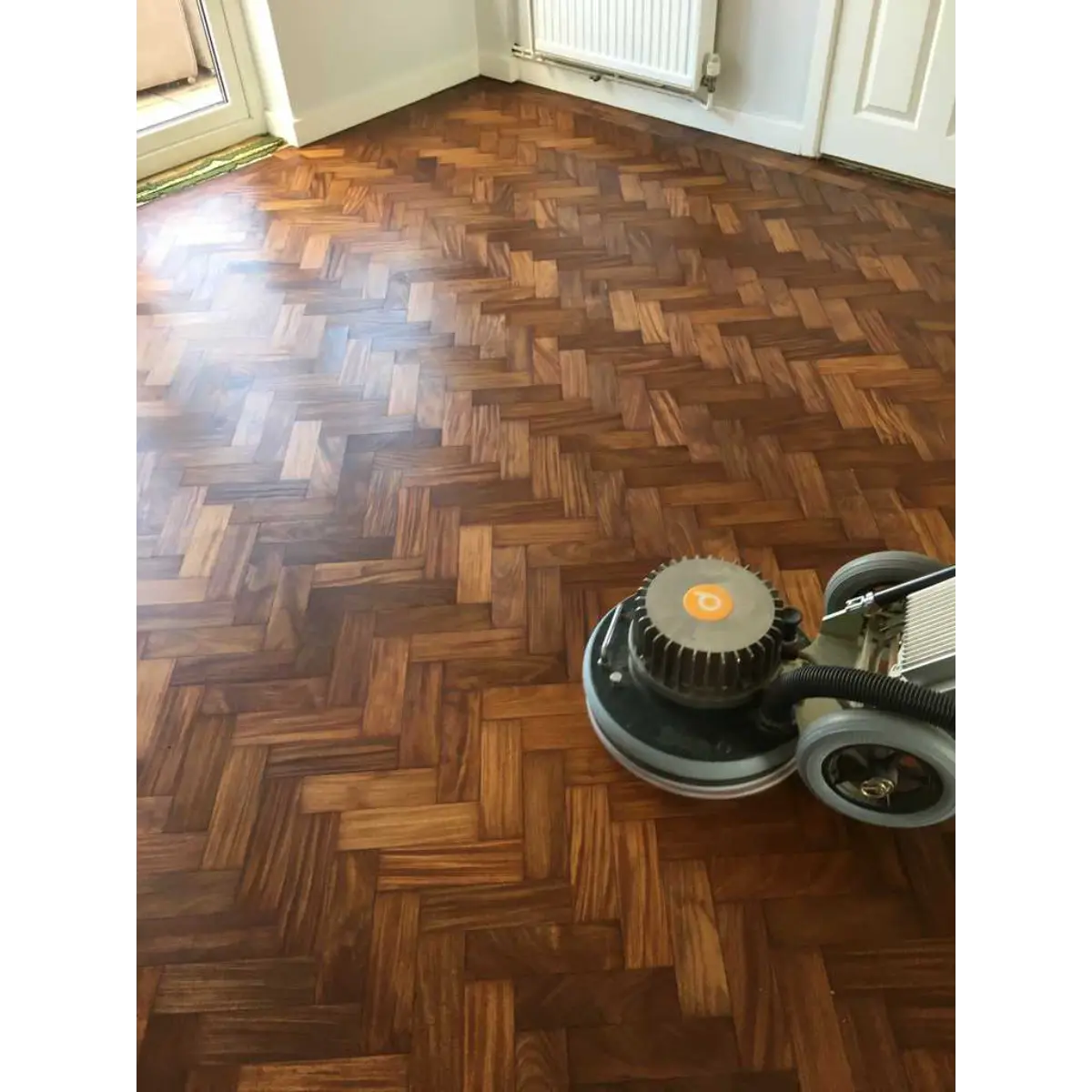 Commercial wood floor restoration can refresh suitable existing flooring while retaining the character that belongs in your premises. At Sussex Floor Restoration, we consider the condition of the timber, how your business uses the space and what needs to happen before the floor returns to service. In a busy pub, restaurant or hotel, wooden floors get a lot of use. Customers bring in grit from outside, chairs move across dining areas, and the same walkways carry hundreds of footsteps. Eventually, regular cleaning stops making the difference it once did. Quick Summary Commercial wood floor restoration can involve preparation, sanding and refinishing to improve worn timber and renew its protection. The right approach depends on the floor’s condition and daily demands. Planning around business operations, allowing sufficient drying and curing time, and following a suitable maintenance routine all help protect the result. When Does a Commercial Wooden Floor Need Attention? A floor that looks dull does not automatically need sanding. Cleaning residue or ingrained dirt may be affecting its appearance, while some floors with an intact finish may benefit from professional maintenance or a suitable recoat. Other signs suggest more extensive attention is needed: - Walkways look noticeably different from quieter areas. - The protective coating has worn through to exposed timber. - Scratches remain obvious after cleaning. - Discolouration has developed around entrances or seating. - Boards or parquet blocks have become loose. An assessment helps distinguish surface maintenance from fuller wooden floor restoration. Addressing deterioration early can also prevent everyday wear from becoming a more involved problem. How Worn Floors Affect the Feel of Your Premises Flooring forms a large part of what customers see when they enter. A dining room may have carefully chosen furniture and fresh paintwork, yet a scratched, patchy floor can leave the space feeling unfinished. That does not mean every sign of age should disappear. Original boards in a traditional pub or parquet in a hotel reception can contribute to the building’s appeal. The aim is to recover a clean, considered appearance while retaining that character. Restoring usable flooring also keeps existing materials in service, making it worth exploring before committing to replacement. What Does Commercial Wood Floor Restoration Involve? We begin by looking at the timber, existing finish, previous wear and any areas needing attention. The floor must have sufficient usable wood remaining for the proposed sanding, particularly with engineered flooring or boards that have been restored before. Where full restoration is appropriate, the work generally involves: 1. Preparing the area and addressing agreed repairs. 2. Sanding progressively to remove worn coatings and surface damage. 3. Working carefully around edges, corners and fixed features. 4. Preparing the surface for a compatible finishing system. 5. Applying the finish and explaining aftercare. Our wood floor sanding service uses extraction equipment to provide a 98% dustless process. Some fine dust can remain, so preparation and protection still matter. Pub Floor Sanding, Restaurant Floors and Hotel Spaces Different premises put different demands on their floors. Even within one business, the busiest areas may need particular consideration. Commercial space Typical demands Restoration priorities Pubs and bars Concentrated footfall, spills and moving stools Suitable protection, practical cleaning and retaining the venue’s character Restaurants Chair movement, food spills and regular cleaning A durable finish and clear maintenance instructions Hotels Luggage, entrance traffic and prominent reception areas Consistent presentation and carefully planned access Shops and showrooms Repeated customer routes and moving displays Protection for busy walkways and furniture contact points Pub floor sanding, for example, needs to account for the practical demands around the bar as well as the appearance of quieter seating areas. We look at how the whole space works before recommending treatment. Choosing a Finish for Heavy Footfall The finish needs to suit commercial use, the timber and your maintenance arrangements. Appearance matters, but so does how the surface will cope with everyday business activity. A suitable commercial lacquer can provide a hard-wearing protective coating. Oil-based systems offer different visual and maintenance characteristics, with product suitability assessed for the particular setting. No single finish is best for every premises. We would discuss: - The volume and pattern of foot traffic. - Exposure to spills and frequent cleaning. - Your preferred colour and sheen. - The maintenance your team can realistically carry out. Floor refinishing should leave you with a surface you understand how to care for. A durable coating still needs regular attention; it does not make the timber immune to scratches or moisture. Planning Commercial Floor Sanding Around Your Business For business owners, the practical question is often when the work can happen. An early discussion gives us the opportunity to consider quieter periods, planned closures and any dates when the space must be available. Furniture needs somewhere to go, and the work area must remain accessible to the team while being kept clear of customers and staff. Allow Time Before Normal Trading Resumes Finishing the application is not the same as having a floor ready for full commercial use. Light foot traffic, furniture replacement, cleaning and heavy use may each have different waiting periods. These depend on the selected products and site conditions, so the schedule should follow the finishing system’s requirements. Phased restoration may be worth discussing where rooms can be separated. However, access routes, coating boundaries and the finished appearance must all be considered before deciding whether that approach will work. Protecting Your Floor After Restoration A simple, consistent care routine helps preserve the investment in wood floor restoration. Use effective entrance matting to reduce tracked-in grit, and remove loose dirt regularly. Wipe up spills promptly and use cleaning products suited to the finish, avoiding excessive water. Furniture feet also deserve attention. Protective pads should be checked and replaced when worn, especially beneath dining chairs that move throughout the day. Manufacturer maintenance guidance similarly highlights furniture protection as part of caring for commercial lacquered floors. Give cleaning staff clear instructions and inspect busy routes regularly. Where suitable, timely professional maintenance or recoating may extend the interval before another full sanding is necessary. Commercial Wood Floor Restoration with Sussex Floor Restoration Commercial wood floor restoration brings together appearance, practical protection and sensible planning. The right treatment can refresh your premises while keeping the original timber working for your business. At Sussex Floor Restoration, we assess your floor and discuss the space, expected use and available timescale before recommending an approach. Our floor restoration process includes preparation guidance and aftercare, helping you plan both the work and what follows. To discuss flooring in your pub, restaurant, hotel or other commercial premises, get in touch. Call: 01444 810505 Email: info@sussexfloorrestoration.co.uk Website: sussexfloorrestoration.co.uk Frequently Asked Questions About Commercial Wood Floor Restoration Can a heavily worn commercial wooden floor be restored? Often, yes, provided the timber is structurally suitable and enough usable thickness remains. Worn finishes and surface scratches can make a floor look worse than its underlying condition. Serious damage, movement and previous sanding need assessing before the work is agreed. How do you know whether a floor needs cleaning, recoating or sanding? The condition of the protective finish is an important starting point. Dirt and residue may respond to professional cleaning, while an intact but worn coating may be suitable for recoating after preparation. Exposed timber or more serious damage can require fuller restoration. How long does commercial wood floor restoration take? The timescale depends on the area, floor condition, preparation required and finishing system. Furniture removal and the waiting time before normal use also need to be included. We can explain the likely programme after assessing your premises. Will the business need to close during restoration? The area being restored needs to remain out of use during the work and for the required period afterwards. Whether the whole business needs to close depends on its layout, access and operations. This should be discussed before booking the project. Can restoration be carried out in separate areas? Sometimes, particularly where rooms can be isolated and alternative access is available. Open-plan premises can be more difficult to divide without affecting the finish or business operations. Phasing needs assessing for the individual property. What finish is suitable for a busy pub or restaurant floor? A finishing system rated for the expected commercial demands is essential. Suitable lacquers and oil systems have different appearance and maintenance requirements. We consider footfall, spills, cleaning routines and the timber before recommending an option. How much dust does commercial floor sanding create? Our sanding equipment uses extraction to provide a 98% dustless service. It greatly reduces dust, but does not eliminate it entirely. Nearby areas and items still need appropriate preparation and protection. Can sanding remove old drink stains and scratches? Sanding can remove many surface scratches and marks, but deeply penetrated stains or damage may remain. The amount of timber that can safely be removed also limits the result. We assess affected areas and explain realistic expectations beforehand. When can furniture and customers return to the floor? The timing depends on the chosen finish and conditions during drying and curing. A floor may accept light foot traffic before it is ready for furniture or heavy customer use. Follow the specific return-to-use guidance provided for the treatment. How should a restored commercial wooden floor be maintained? Remove grit frequently, deal with spills promptly and clean with products approved for the finish. Maintain entrance mats and furniture protection, and avoid soaking the floor. Regular checks of busy areas help identify wear before protection is lost.